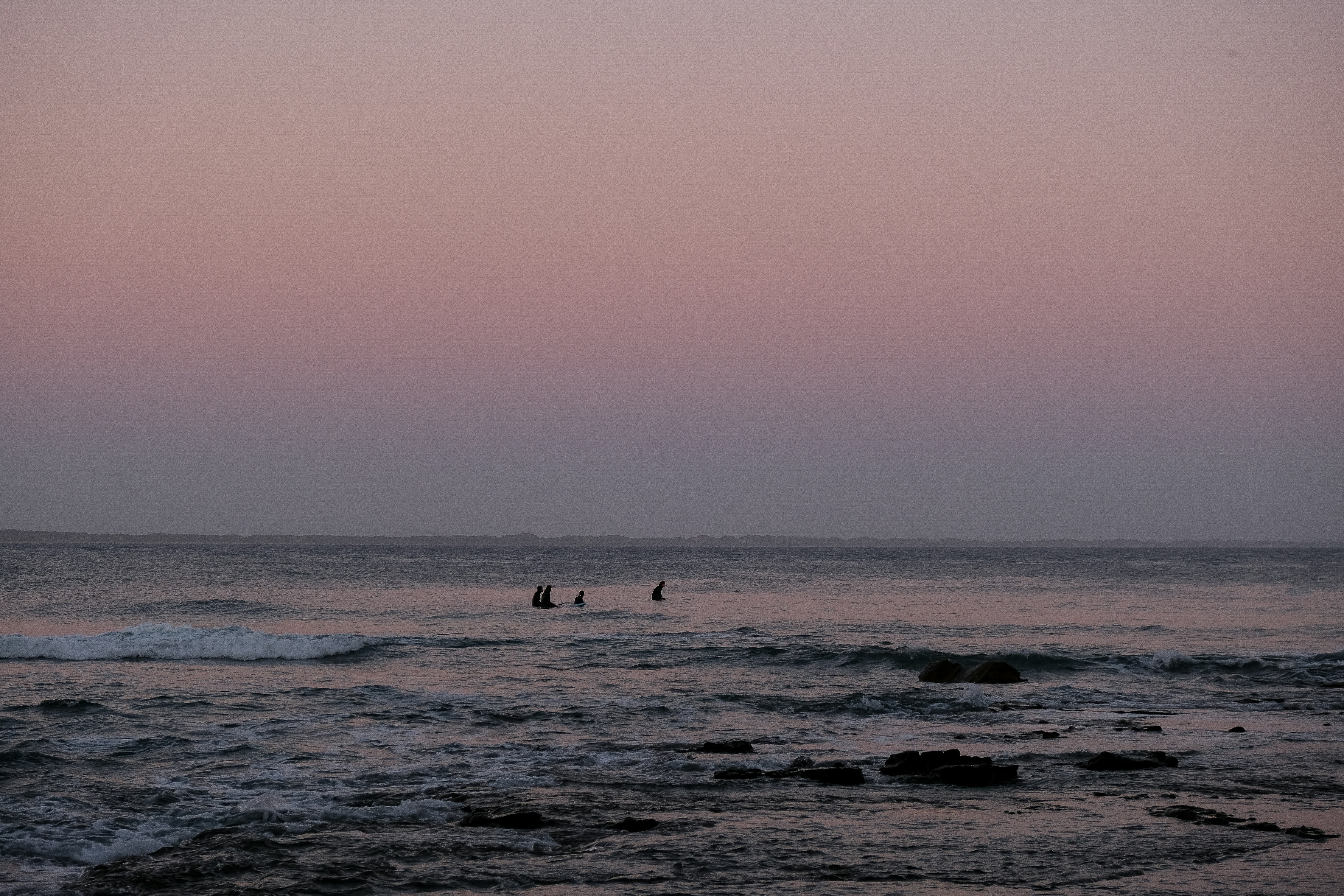 person surfing on sea waves during daytime